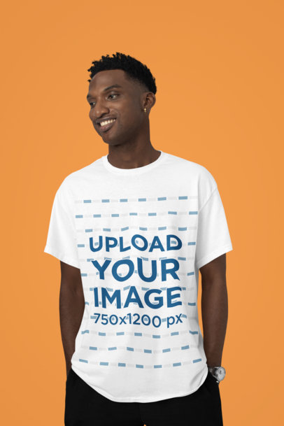 T-Shirt Mockup Featuring a Smiling Man Posing in a Studio Against a Colorful Backdrop