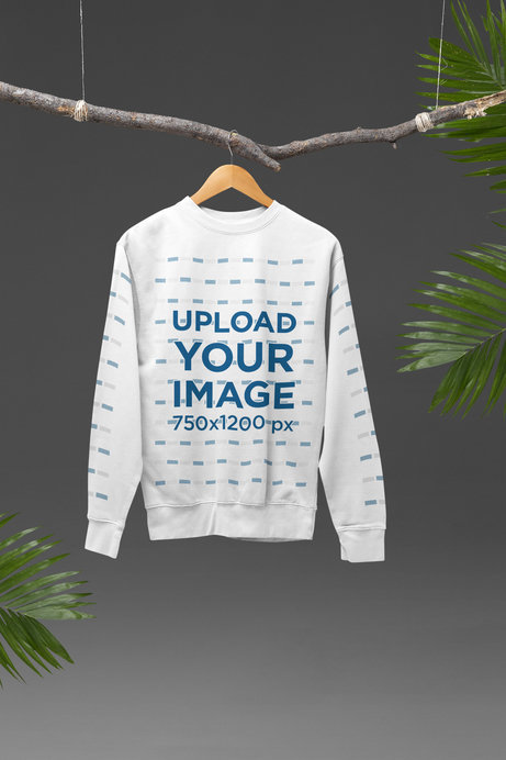Mockup of a Cotton Heritage Sweatshirt Hanging from a Tree Branch