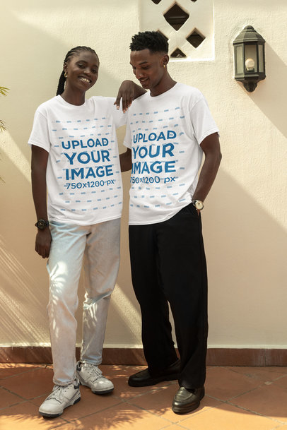 Round-Neck T-Shirt Mockup of a Smiling Man and Woman Posing Against a Wall