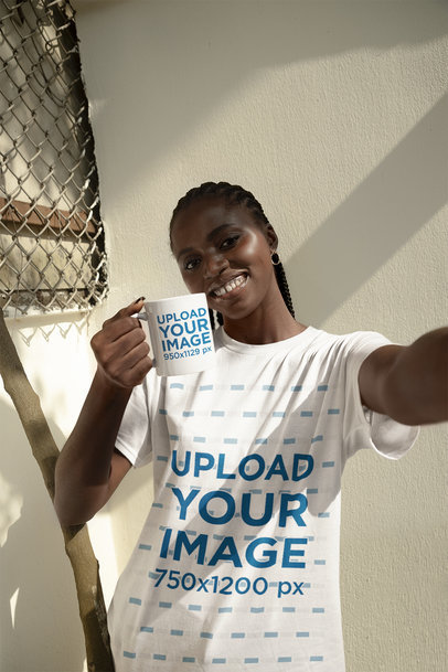 T-Shirt Mockup Featuring a Cheerful Woman Taking a Selfie With a Coffee Mug m37894
