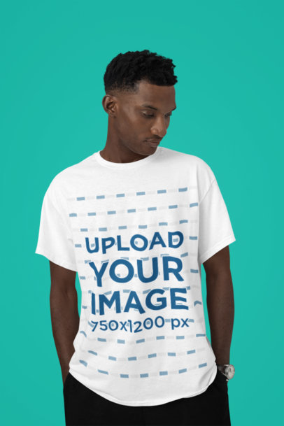 T-Shirt Mockup Featuring a Man Posing With a Serious Look in a Studio