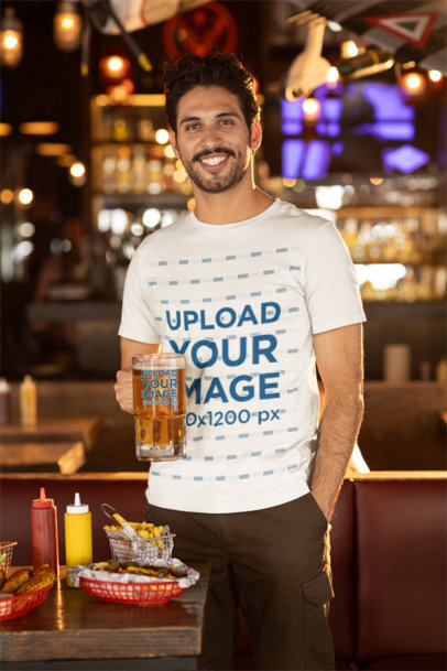 Bella Canvas Tee Mockup of a Smiling Bearded Man Holding a Beer Glass in a Bar m38082