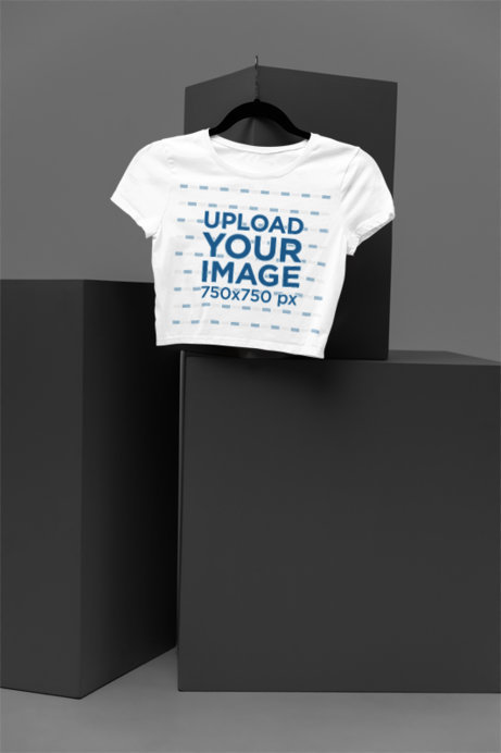 Mockup of a Crop Top from Bella Canvas Hanging in a Minimalist Setting