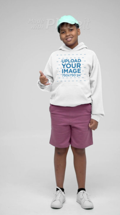 Gildan Hoodie Video of a Happy Boy Making a Cool Pose in a Studio