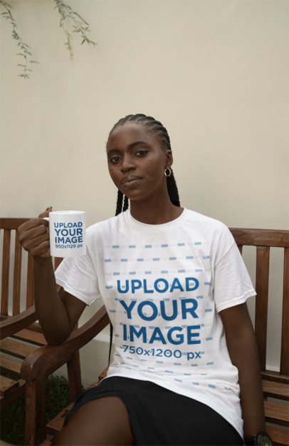 Round-Neck Tee Mockup of a Woman Sitting on a Bench and Holding a Coffee Mug m37893