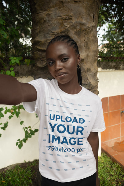T-Shirt Mockup Featuring a Woman Taking a Selfie With a Serious Look