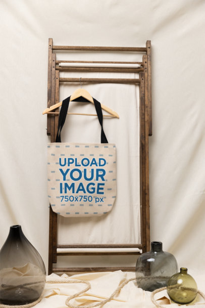 Mockup Featuring a Sublimated Tote Bag Hanged in a Rustic Setting m37623