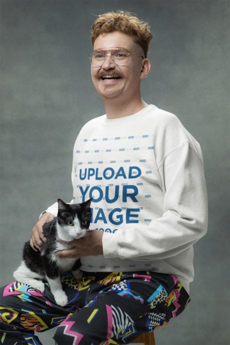 Gildan Sweatshirt Mockup of a Happy Man Posing with His Kitten in a Studio