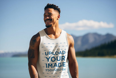 AI-Generated Mockup of a Man with Arm Tattoos Wearing a Tank Top by a Lake