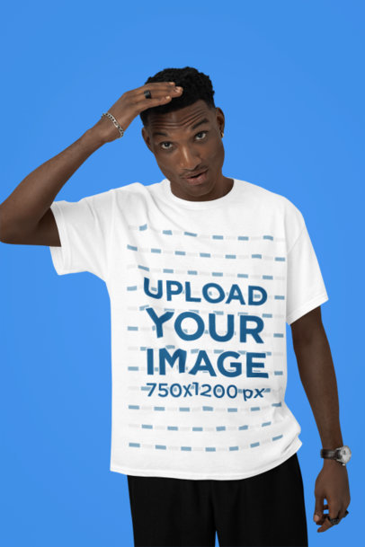 T-Shirt Mockup Featuring a Man Posing in a Studio With a Hand on His Head