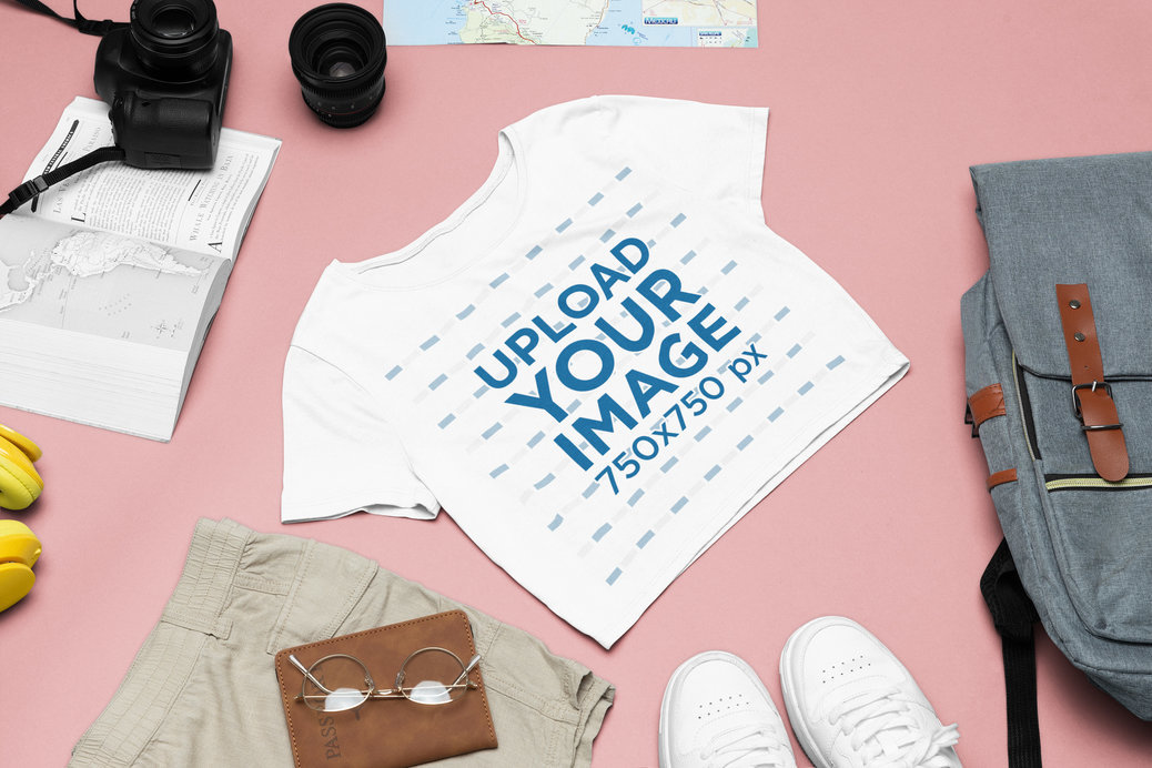 Travel Outfit Mockup of a Bella Canvas Crop Top Placed Next to an Open Book and a Camera