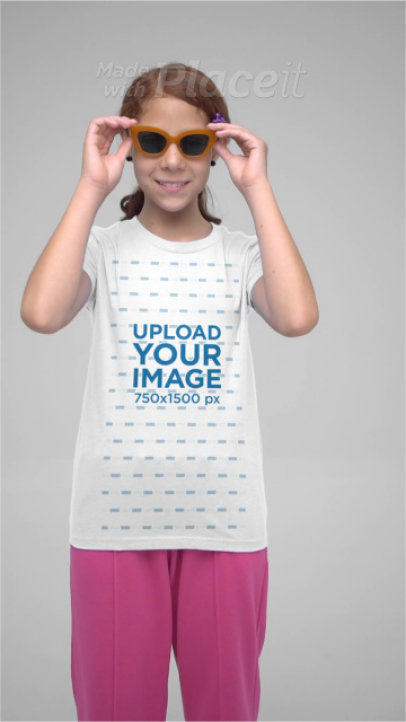 Bella Canvas T-Shirt Video of a Smiling Girl With Sunglasses Posing in a Studio