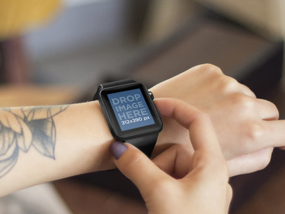 Mockup of a Young Tattooed Woman Using her Black Apple Watch