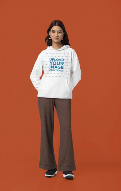 Mockup of a Woman Wearing a Pullover Hoodie from Gildan in a Studio