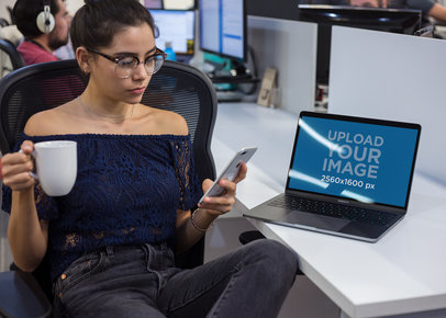 MacBook Mockup Featuring a Woman Taking a Break at the Office