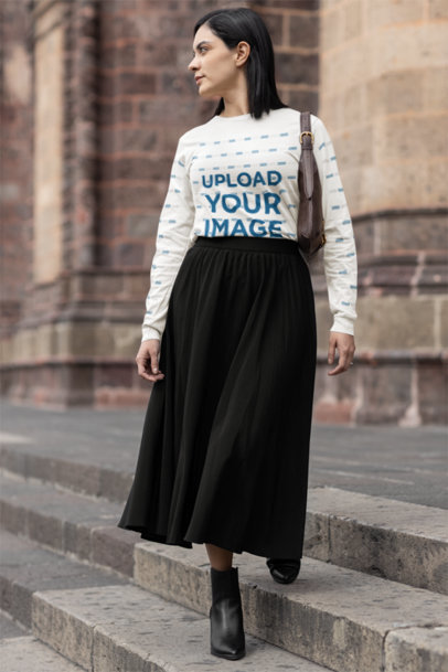 Bella Canvas Long-Sleeve Tee Mockup Featuring a Woman in a Modest Style Walking by a Church