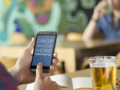 Mockup of College Student Using Android Phone and Studying While Out Having a Beer