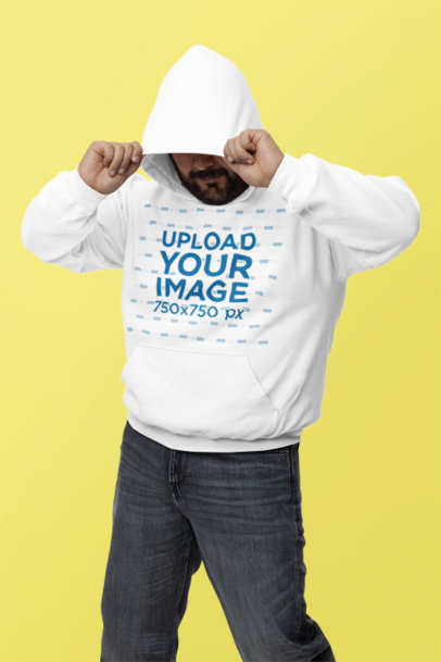 Gildan Mockup Featuring a Bearded Man Covering His Face With His Pullover Hoodie