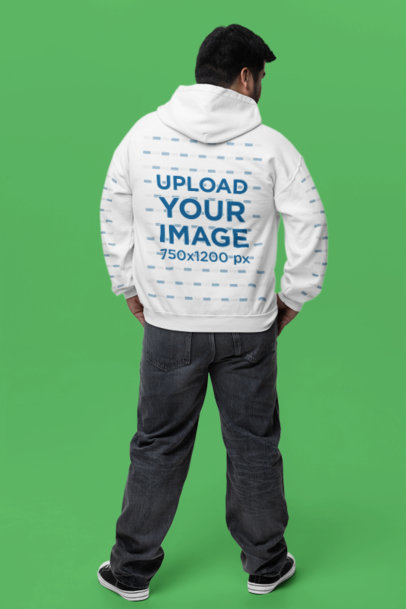 Back-View Gildan Hoodie Mockup of a Man Posing in a Studio With Hands on His Pockets