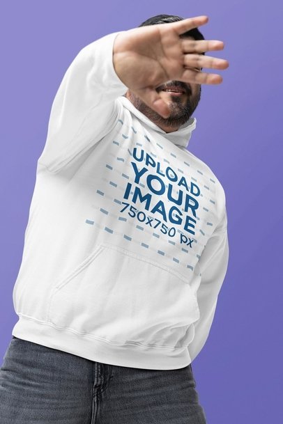 Gildan Hoodie Mockup of a Smiling Man Covering His Face With His Hand in a Studio