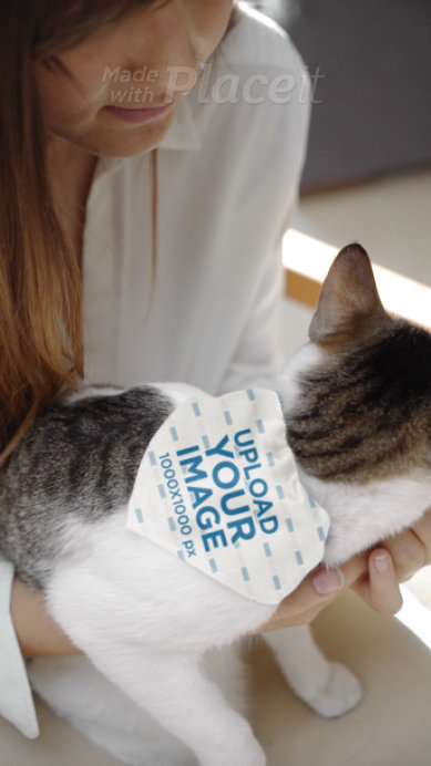 Video of a Woman Carrying a Cat With a Bandana