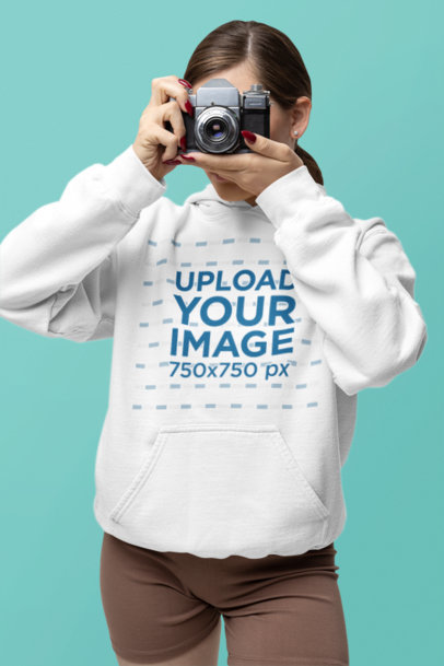 Gildan Hoodie Mockup Featuring a Woman Taking a Photo With a Vintage Camera