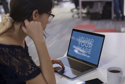 MacBook Mockup of a Woman Working on a White Table