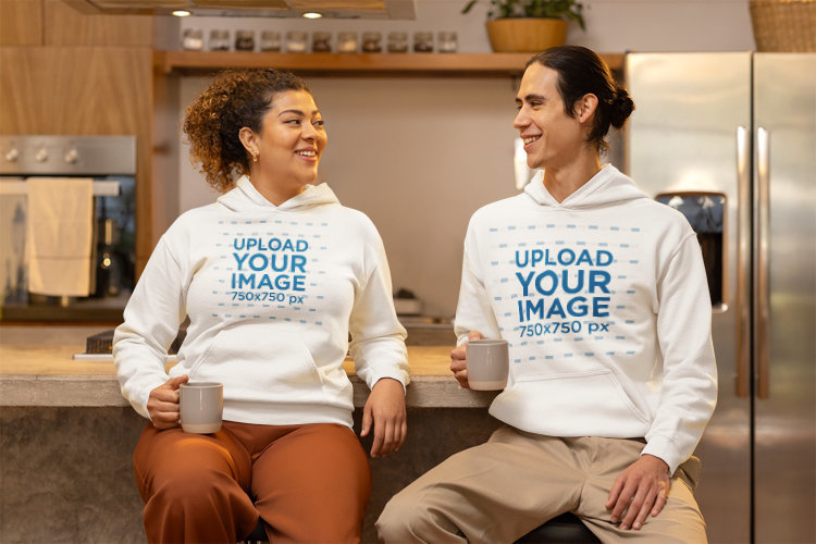 Gildan Pullover Hoodie Mockup of a Joyful Woman and Man Enjoying a Coffee Time