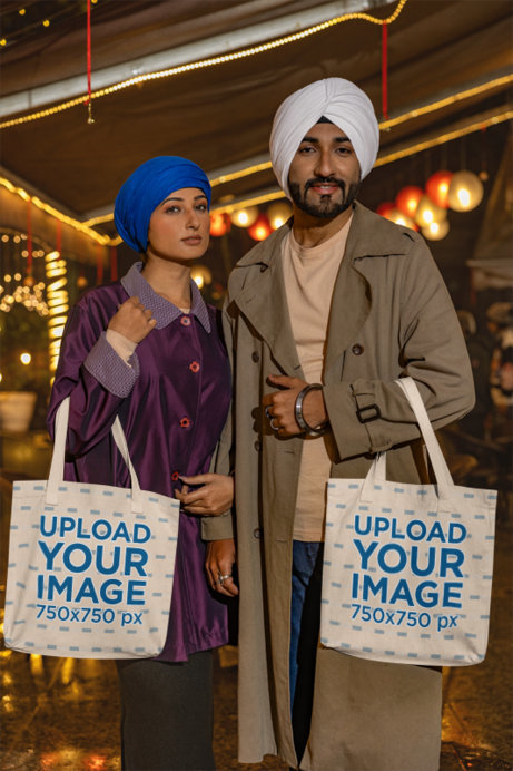 Mockup of a Man and a Woman Wearing Turbans and Carrying Sublimated Tote Bags