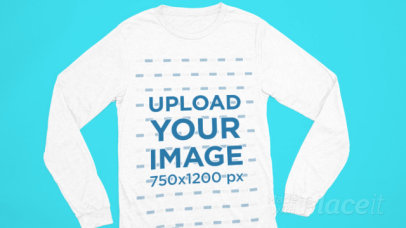 Video of a Bella Canvas Long-Sleeve Tee Lying on a Colorful Surface