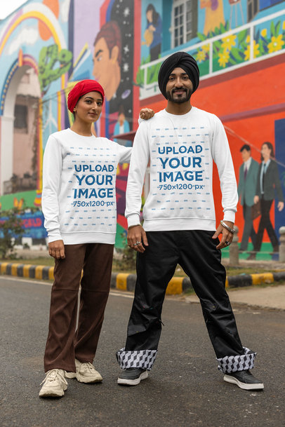 Sweatshirt Mockup Featuring a Happy Couple With Turbans Posing Against a Mural