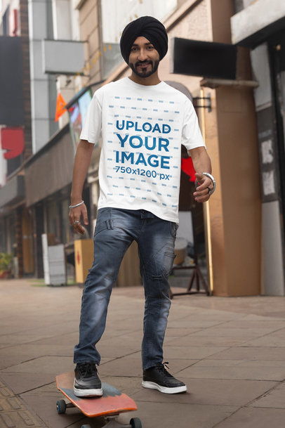 Blinkstore T-Shirt Mockup of a Man with a Turban Posing with a Skateboard