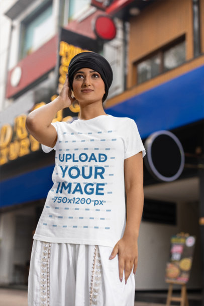 Scott International T-Shirt Mockup of a Woman in a Turban Posing in the Street
