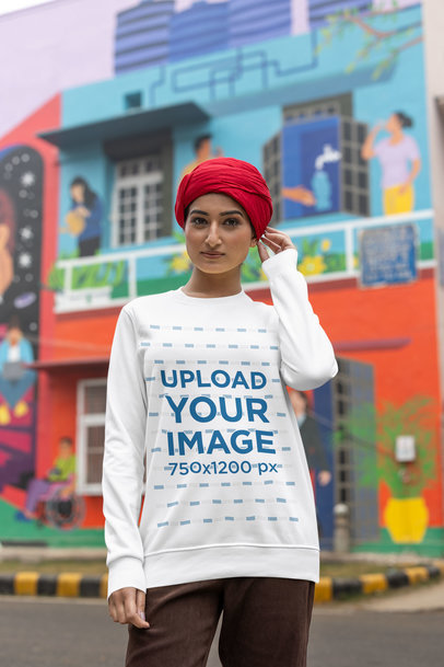Crewneck Sweatshirt Mockup of a Woman with a Turban on Her Head Posing on a Street 