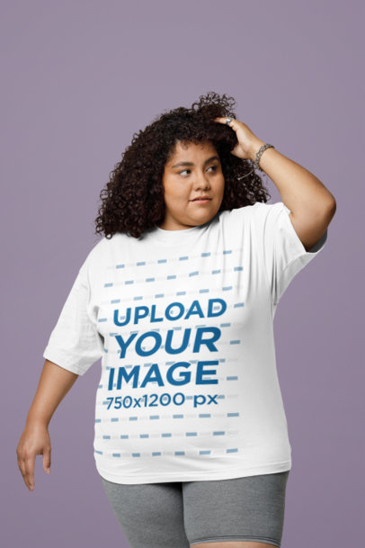 Oversized T-Shirt Mockup Featuring a Woman With Curly Hair Posing in a Studio