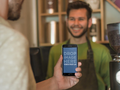Young Man Using Android Phone at Coffee Shop Mockup Template