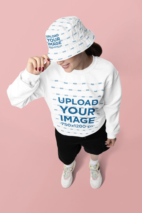 Bucket Hat Mockup Featuring a Happy Woman Wearing a Gildan Sweatshirt in a Studio