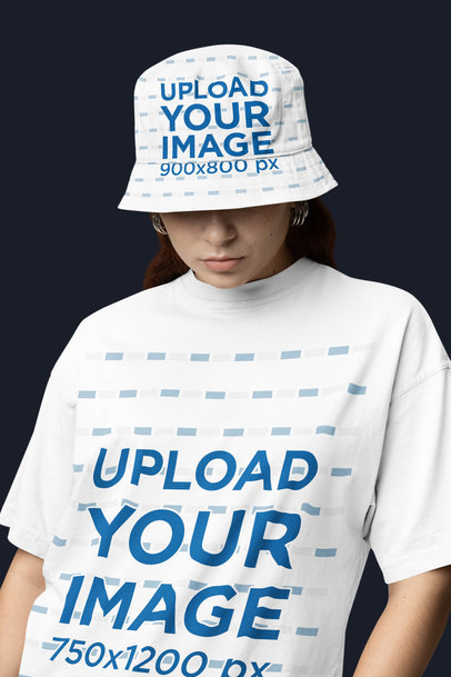 Oversized T-Shirt Mockup of a Serious Woman Posing in a Studio With a Sublimated Bucket Hat