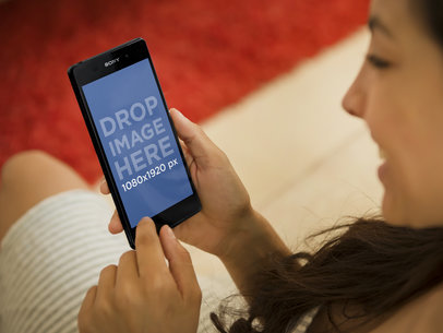 Young Woman Using Sony Xperia Z3 in a Living Room 