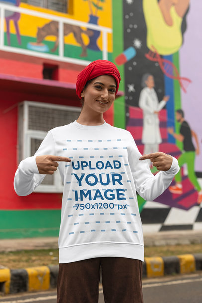Mockup of a Woman with a Turban Pointing at Her Crewneck Sweatshirt