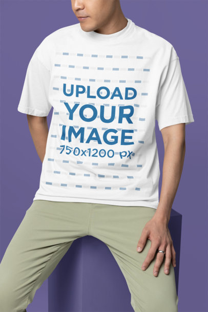 Mockup Featuring a Man Wearing an Oversized Round-Neck Tee in a Studio
