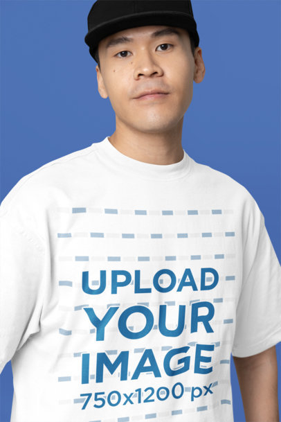 Oversized Tee Mockup of a Serious Man Standing Against a Customizable Background