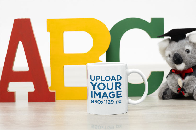 Mockup of an 11 oz Coffee Mug Placed to Colorful Letters for a Graduation