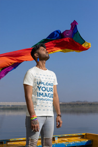 Scott International T-Shirt Mockup Featuring a Man Posing Against a Pride Flag