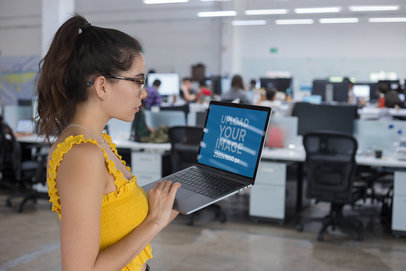MacBook Mockup of a Woman Working while Standing on her Feet