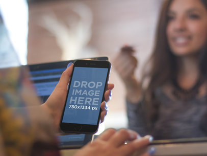 Mockup of Cashier Using Black iPhone 6 to Take a Payment