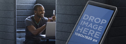 Young Man Using His Smartphone at his Workstation