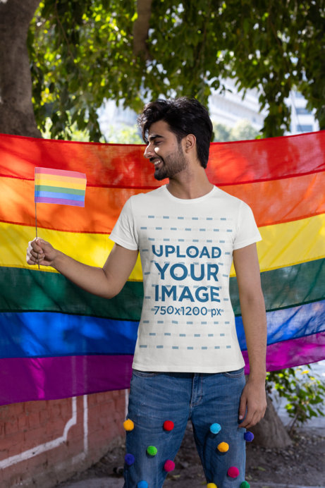 T-Shirt Mockup of a Happy Man Celebrating Pride Month with a Rainbow Flag 