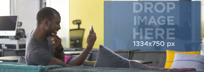 Screenshot Mockup of Young Man Using Smartphone at Office Lounge