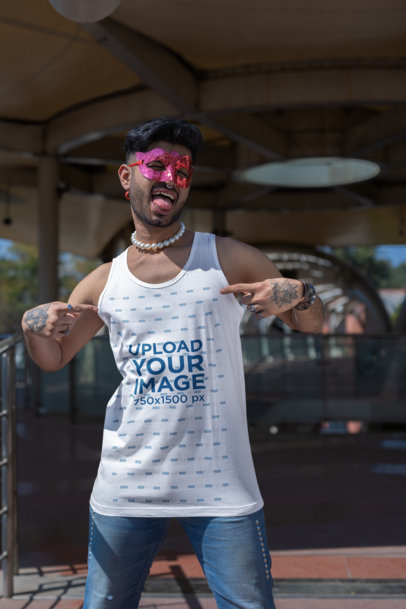 Mockup of a Joyful Man with a Mask Pointing at His Tank Top at a Gay Pride Event 